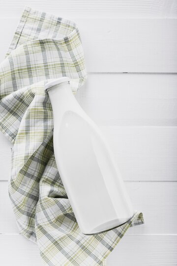 Flat lay milk bottle with kitchen towel
